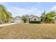 Inviting single-story home with a manicured lawn, lush landscaping, and an attached garage at 2435 Alton Rd, Deltona, FL 32738