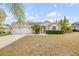 Charming single-story home featuring a well-manicured lawn and an attached two-car garage at 2435 Alton Rd, Deltona, FL 32738