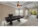 This game room features a pool table, neutral walls, tile flooring, and natural light from the large windows and sliding glass door at 2435 Alton Rd, Deltona, FL 32738