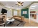 Staged living room featuring modern furniture, a fireplace, and seamless transition to kitchen at 2435 Alton Rd, Deltona, FL 32738