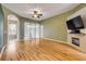 Bright and airy living room featuring hardwood floors and a cozy fireplace at 2435 Alton Rd, Deltona, FL 32738