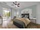 Staged main bedroom with a sliding glass door, ceiling fan, and area rug at 2435 Alton Rd, Deltona, FL 32738