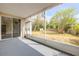 Covered patio overlooking the green backyard has string lights and is accessible via a sliding glass door at 2435 Alton Rd, Deltona, FL 32738