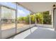 Screened-in patio overlooking a fenced backyard features a tile floor and outdoor lighting perfect for entertaining at 2435 Alton Rd, Deltona, FL 32738