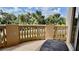 Inviting outdoor balcony with stone railings offering a view of the tropical greenery and neighborhood at 250 Minorca Beach Way # 206, New Smyrna Beach, FL 32169