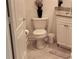 Neutral toned half bathroom featuring a ceramic toilet and granite topped vanity at 250 Minorca Beach Way # 206, New Smyrna Beach, FL 32169