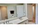 Bathroom with dual sinks and a large mirror at 250 Minorca Beach Way # 206, New Smyrna Beach, FL 32169