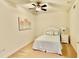 Cozy bedroom with a ceiling fan, carpeted floors, and coastal artwork at 250 Minorca Beach Way # 206, New Smyrna Beach, FL 32169