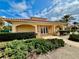 Charming clubhouse exterior featuring a terracotta roof, manicured hedges, and an inviting entrance with architectural details at 250 Minorca Beach Way # 206, New Smyrna Beach, FL 32169