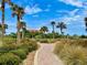 Beautiful community park features a walking path surrounded by lush landscaping at 250 Minorca Beach Way # 206, New Smyrna Beach, FL 32169