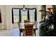 Elegant dining room featuring a wooden table set for six, complemented by windows and natural light at 250 Minorca Beach Way # 206, New Smyrna Beach, FL 32169