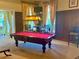 Well-lit game room showcasing a billiard table, comfortable seating, and elegant decor, offering a relaxing recreational space at 250 Minorca Beach Way # 206, New Smyrna Beach, FL 32169