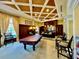 Inviting game room featuring a billiard table, stylish seating, and a bar area, perfect for entertaining and relaxation at 250 Minorca Beach Way # 206, New Smyrna Beach, FL 32169