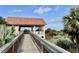 Community gazebo is accessible by a wooden walkway and overlooks the surrounding landscape at 250 Minorca Beach Way # 206, New Smyrna Beach, FL 32169