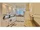 Spacious kitchen with white cabinets, granite countertops, and modern appliances, plus a breakfast nook visible at 250 Minorca Beach Way # 206, New Smyrna Beach, FL 32169