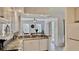 Open kitchen design featuring granite countertops and white cabinetry with stainless steel appliances and a breakfast nook at 250 Minorca Beach Way # 206, New Smyrna Beach, FL 32169