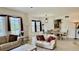 Open-concept living room leading to dining area with large windows and neutral decor, creating a spacious atmosphere at 250 Minorca Beach Way # 206, New Smyrna Beach, FL 32169