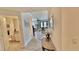 Bright entryway view into living room, showing the neutral color palette and tile flooring throughout the home at 250 Minorca Beach Way # 206, New Smyrna Beach, FL 32169