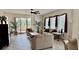 Comfortable living area showcasing tile flooring, sliders to balcony, and ample natural light for a serene living space at 250 Minorca Beach Way # 206, New Smyrna Beach, FL 32169