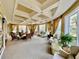 Bright community lounge area with comfortable seating and plenty of natural light through large windows at 250 Minorca Beach Way # 206, New Smyrna Beach, FL 32169