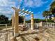 Charming outdoor pergola with seating, offering a peaceful spot with scenic views at 250 Minorca Beach Way # 206, New Smyrna Beach, FL 32169