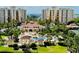 Beautiful resort-style pool area featuring lush landscaping, a charming gazebo, and inviting lounge chairs surrounded by palm trees at 250 Minorca Beach Way # 206, New Smyrna Beach, FL 32169