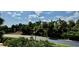 Scenic street lined with mature trees and lush landscaping at 250 Minorca Beach Way # 206, New Smyrna Beach, FL 32169