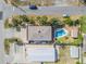 Aerial view of a home with a pool, spacious yard, and surrounding neighborhood near the beach at 2510 S Atlantic Ave, New Smyrna Beach, FL 32169