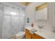 Bathroom features a vanity with wood accents, neutral tile, and a shower with decorative curtain at 2510 S Atlantic Ave, New Smyrna Beach, FL 32169