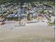 Beachfront view highlighting neighborhood homes along the sandy shoreline and ocean at 2510 S Atlantic Ave, New Smyrna Beach, FL 32169