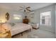 Bright bedroom featuring a ceiling fan, quaint seating, and natural light from two windows at 2510 S Atlantic Ave, New Smyrna Beach, FL 32169