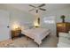 Comfortable bedroom with plush bedding, side tables with lamps, and a stylish ceiling fan at 2510 S Atlantic Ave, New Smyrna Beach, FL 32169