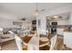 Open-concept dining area, living room, and kitchen with wood floors, comfortable seating, and modern appliances at 2510 S Atlantic Ave, New Smyrna Beach, FL 32169