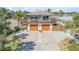 Exterior view of a two-story home featuring a spacious balcony and two-car garage at 2510 S Atlantic Ave, New Smyrna Beach, FL 32169