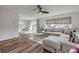 Sunlit living room features a comfortable sectional sofa with a dining area leading outdoors at 2510 S Atlantic Ave, New Smyrna Beach, FL 32169
