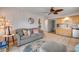 Comfortable living room and kitchen area with appealing nautical decor and decoratively patterned rug at 2510 S Atlantic Ave, New Smyrna Beach, FL 32169