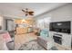Living room has a full kitchen, large television, and patterned rug, creating a comfy living space at 2510 S Atlantic Ave, New Smyrna Beach, FL 32169