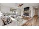 Comfortable living room with a decorative brick fireplace, fan, and wood flooring at 2510 S Atlantic Ave, New Smyrna Beach, FL 32169