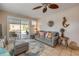 Relaxing living room with a slider door to the pool area, comfy sofa, and fan at 2510 S Atlantic Ave, New Smyrna Beach, FL 32169