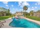 Lush backyard oasis with a refreshing swimming pool, jacuzzi, shed and well-manicured landscaping at 2510 S Atlantic Ave, New Smyrna Beach, FL 32169
