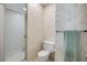 Bathroom with a glass-enclosed shower and classic floral wallpaper at 257 Club House Blvd, New Smyrna Beach, FL 32168