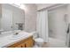 Bathroom features a vanity, toilet, bathtub with shower, and floral wallpaper at 257 Club House Blvd, New Smyrna Beach, FL 32168
