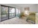 Bright bedroom with wood-look flooring and a sliding glass door to a deck at 257 Club House Blvd, New Smyrna Beach, FL 32168