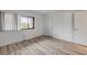 Cozy bedroom with wood-look flooring, bright window, and closet at 257 Club House Blvd, New Smyrna Beach, FL 32168
