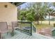 Deck with wooded golf course views, chairs, and railing at 257 Club House Blvd, New Smyrna Beach, FL 32168