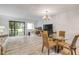 Open-concept living room with balcony access, and dining space at 257 Club House Blvd, New Smyrna Beach, FL 32168