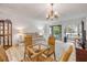 Bright living room with a glass table, cozy seating, and a balcony at 257 Club House Blvd, New Smyrna Beach, FL 32168
