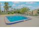 Beautiful blue community pool with blue-tiled trim and surrounding patio at 257 Club House Blvd, New Smyrna Beach, FL 32168