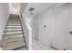 Hallway features a carpeted staircase with white walls leading to the upper level of the home at 257 Club House Blvd, New Smyrna Beach, FL 32168