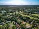 Expansive aerial view of the community, golf course, and surrounding landscape with a private home marked at 257 Sweet Bay Dr, New Smyrna Beach, FL 32168